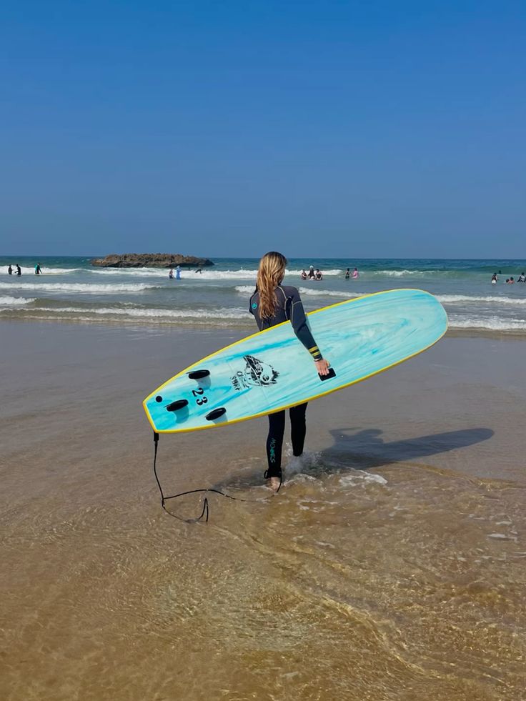 woman surfer Taghazout Morocco surf board beach