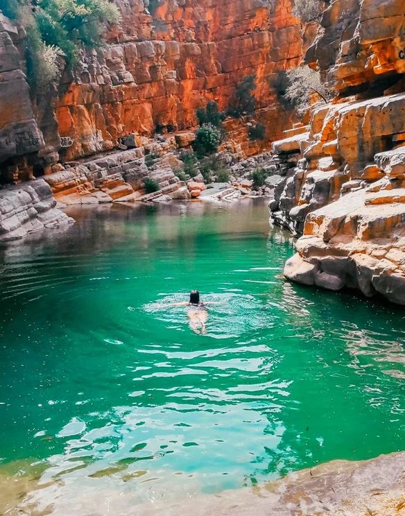 Paradise Valley Agadir swimmer turquoise pool red cliffs Morocco